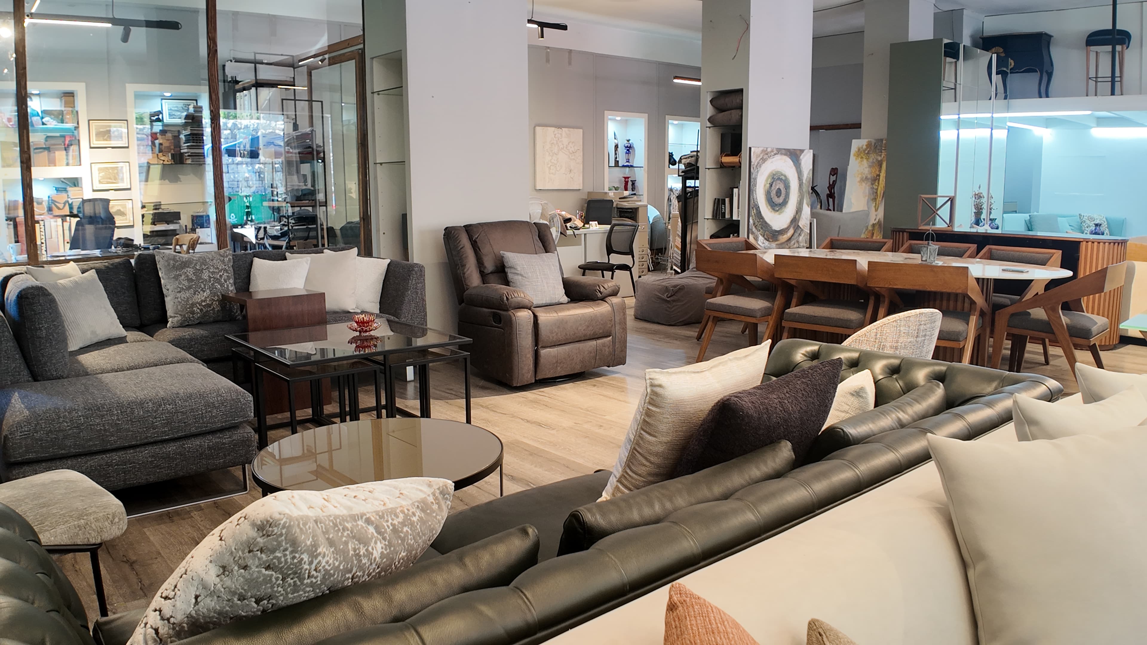 The Gallery LA showroom interior in Baabdet — sofas, recliners, dining, and art on the floor